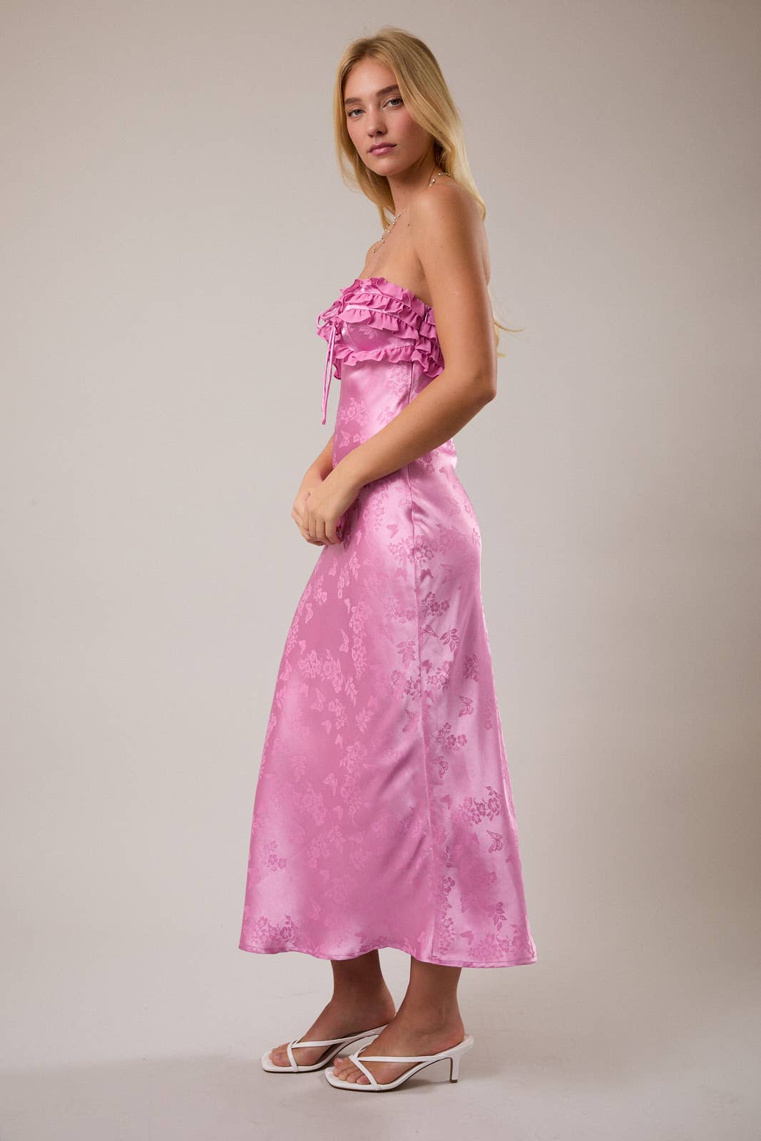 Elegant pink satin maxi dress with ruffled neckline, perfect for summer events and stylish outings.