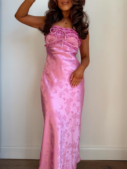 Pink satin floral evening gown with ruffled details and adjustable straps, perfect for special occasions.