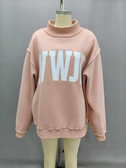 Oversized pink sweatshirt with a white logo, featuring a mock neck and cozy material.