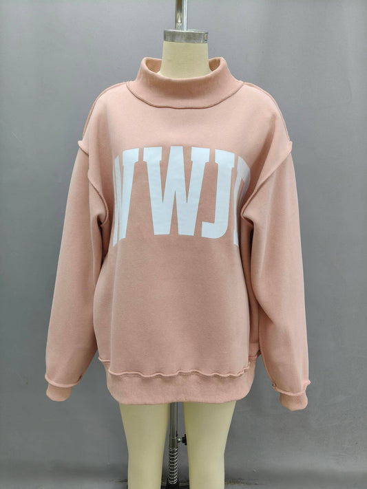 Oversized pink sweatshirt with a white logo, featuring a mock neck and cozy material.