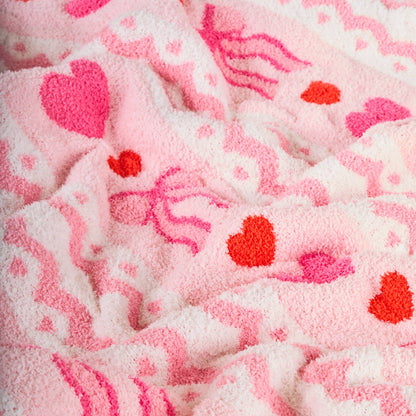 Soft pink towel with heart and jellyfish patterns, perfect for bathrooms and beach outings.