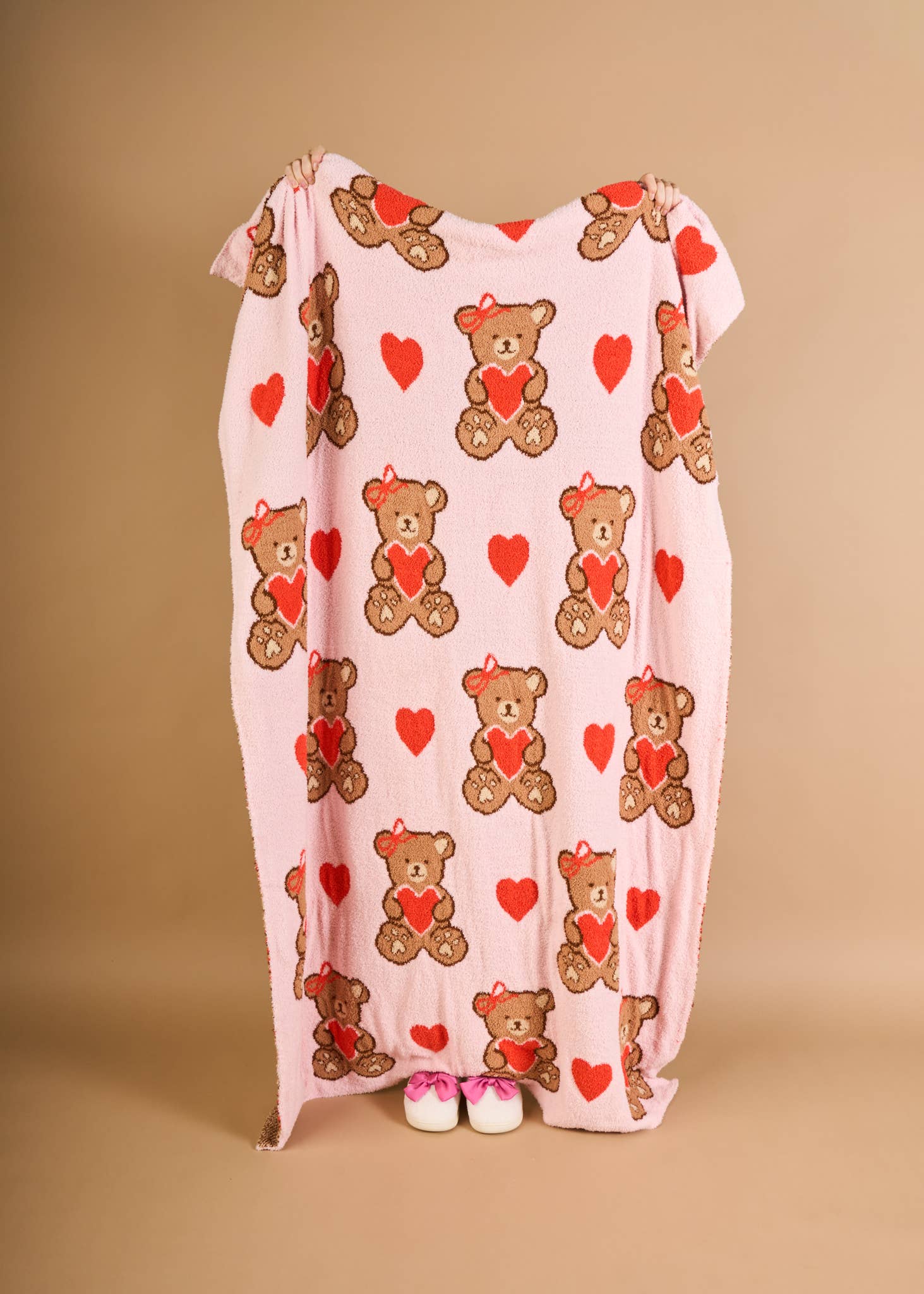 Cozy pink blanket featuring cute teddy bears and hearts, perfect for kids.