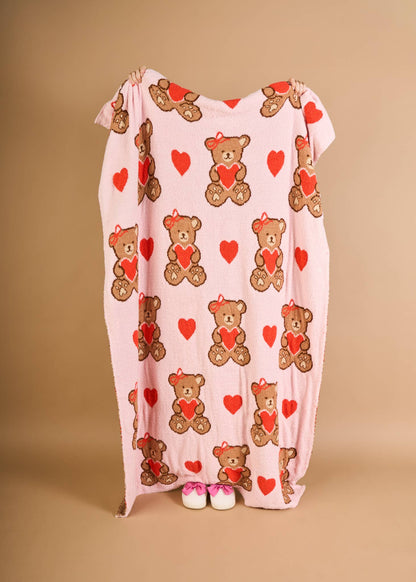 Cozy pink blanket featuring cute teddy bears and hearts, perfect for kids.