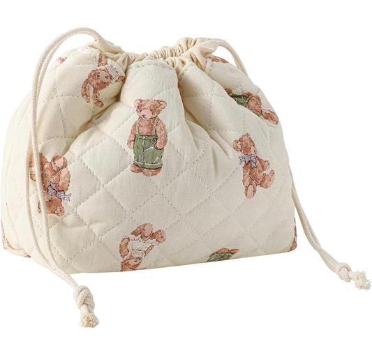 Quilted drawstring bag featuring cute teddy bear prints in soft beige fabric, perfect for storage.
