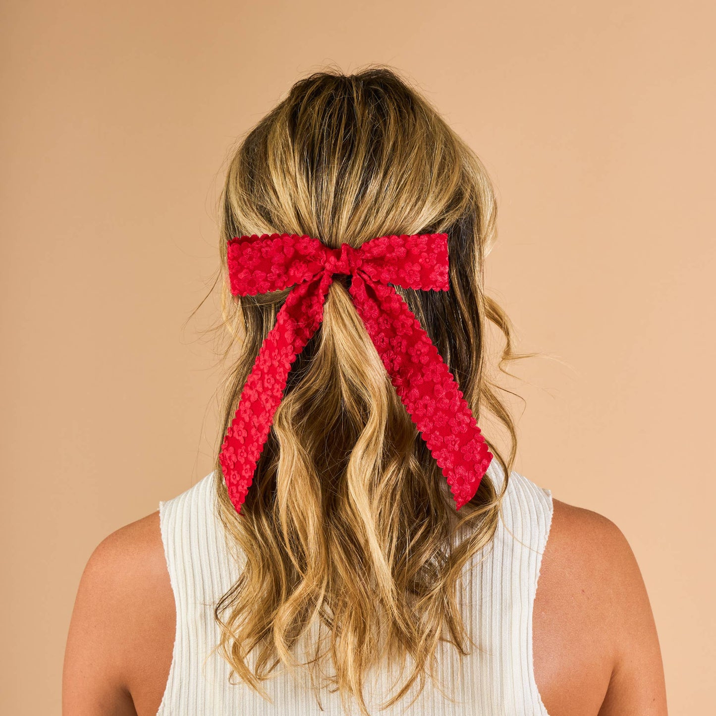 Vibrant red lace hair bow, perfect for stylish hair accessories, tied in a chic ponytail.